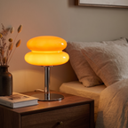 Mira lamp lit on a bedroom nightstand