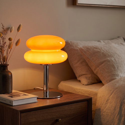 Mira lamp lit on a bedroom nightstand